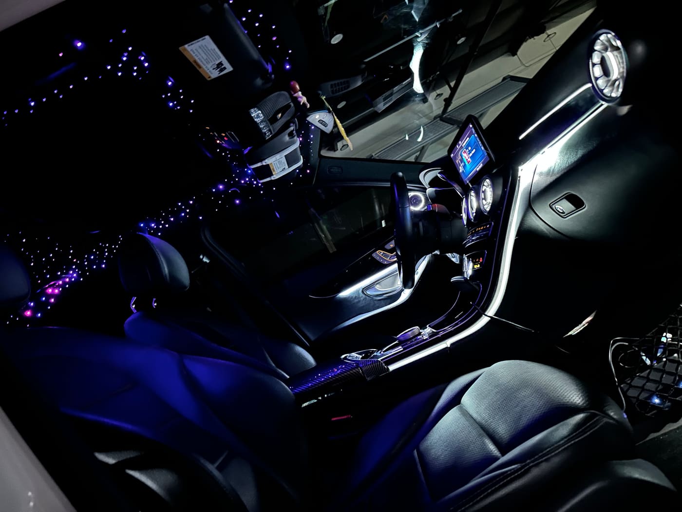 Starlight headliner and illuminated dash trim seen from the open driver door
